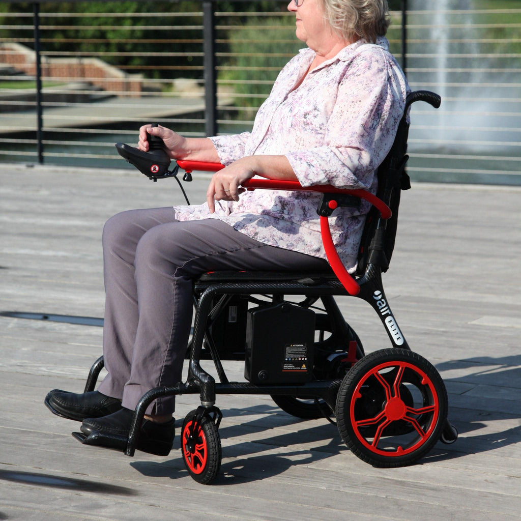 Woman driving a Journey Air Elite power chair outdoors, side profile view